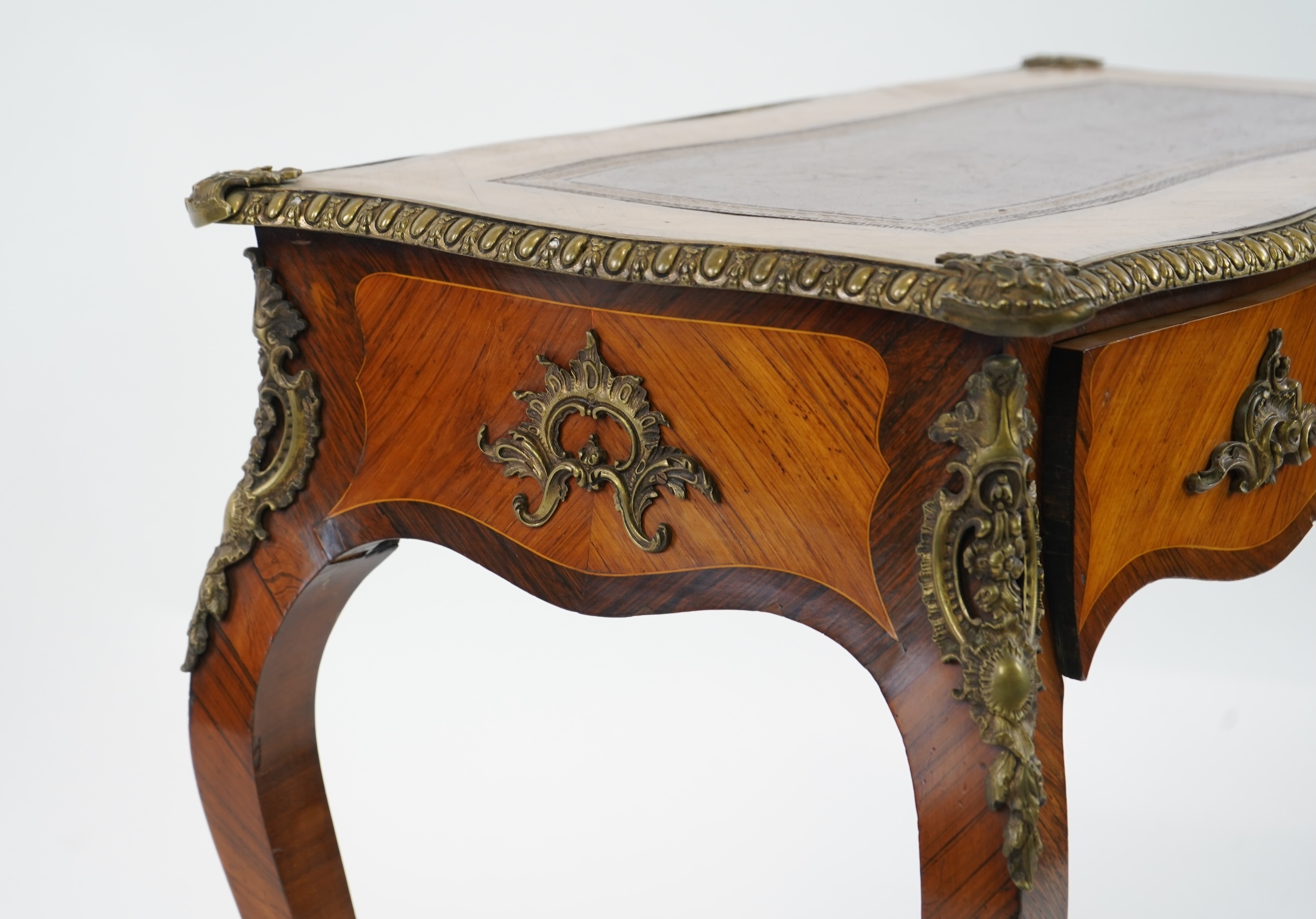 A small Louis XV style gilt metal mounted rosewood and kingwood bureau plat